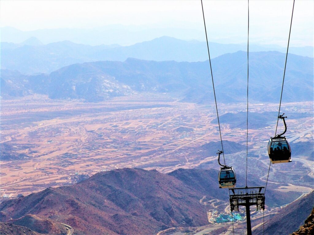 cable car over the mountains during daytime